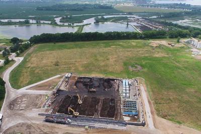 Aerial overview of the excavation area (foreground) and the North Muskegon River and Muskegon Lake (background). Cofferdams and temporary access roads were used to dewater the wetland, and excavate contaminated sediments prior to restoring wetland habitat.