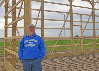 Man standing next to a building frame.
