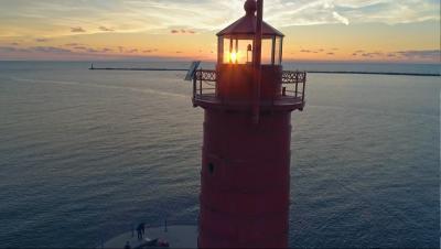 red lighthouse at sunset