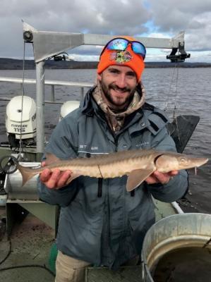 man holding sturgeon