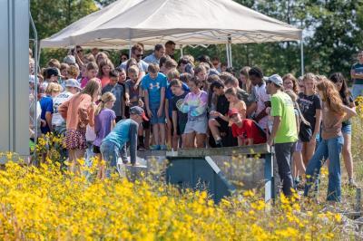 Sixth grade students from local schools in Defiance, Ohio observe the wetland inlet flume that let water flow into the wetlands during a guided tour of the Phosphorus Optimal Wetland Demonstration Project. (Credit: Andre Hampton, USACE)