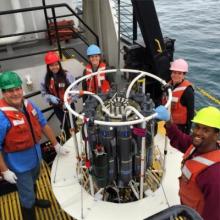 five people on deck of the Lake Guardian with the rosette sampler