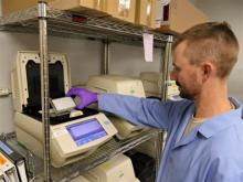 Scientist processes environmental DNA using PCR machines 