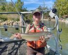 A Biologist holding a lake trout. 